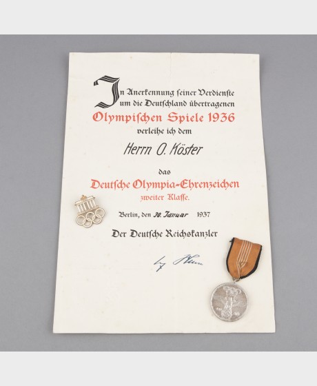 Saksan 2.lk Olympia-ansiomitali kunniakirjalla (Virolainen puolustusministeri Oskar Köster)